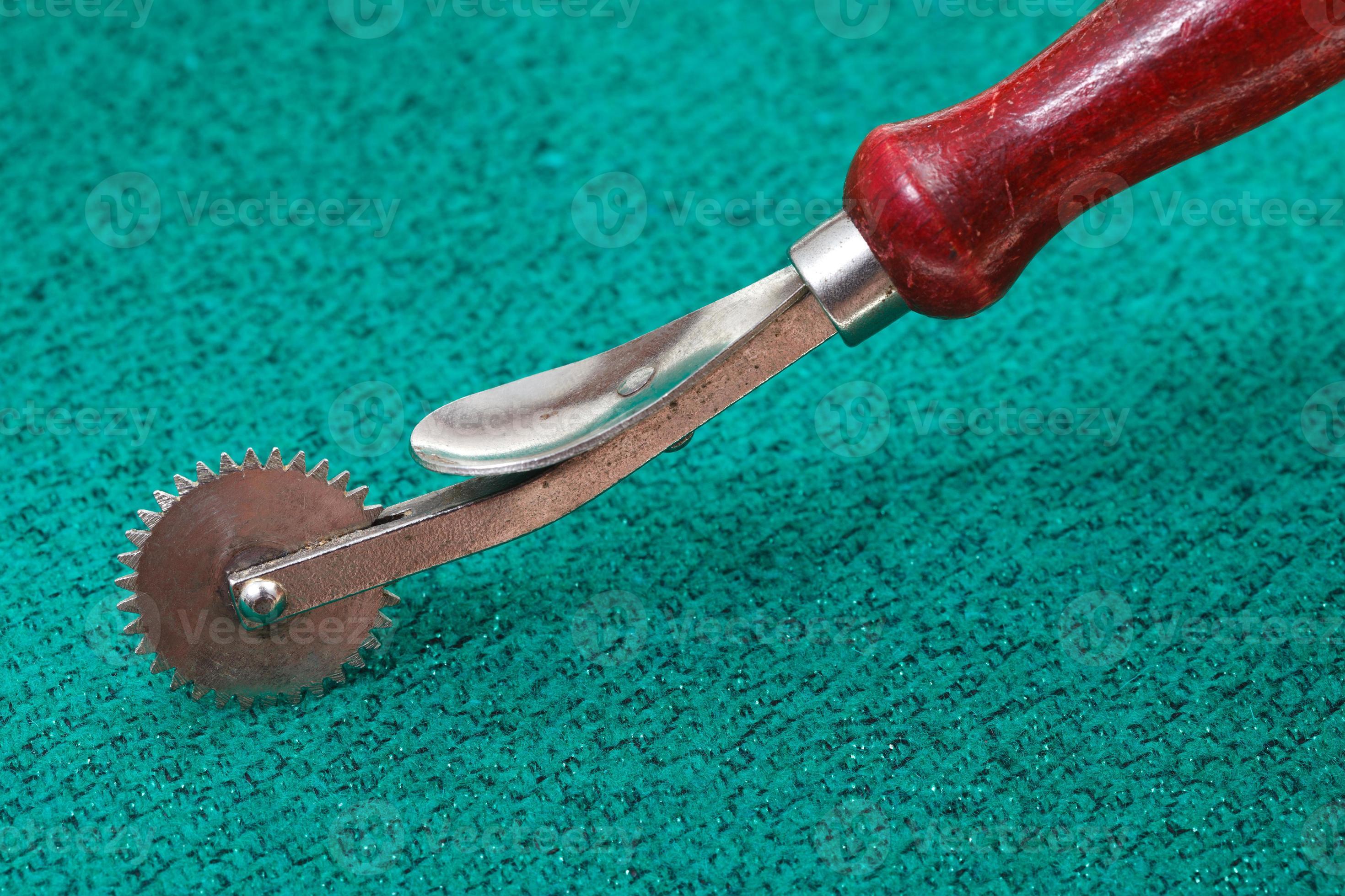 sewing tracing wheel on green textile 11850238 Stock Photo at Vecteezy