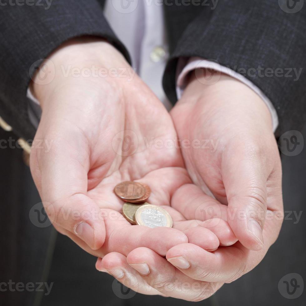 little of coins in businessman's handful photo