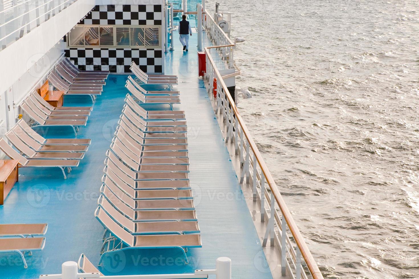 sunbath chairs on side of cruise liner at morning photo