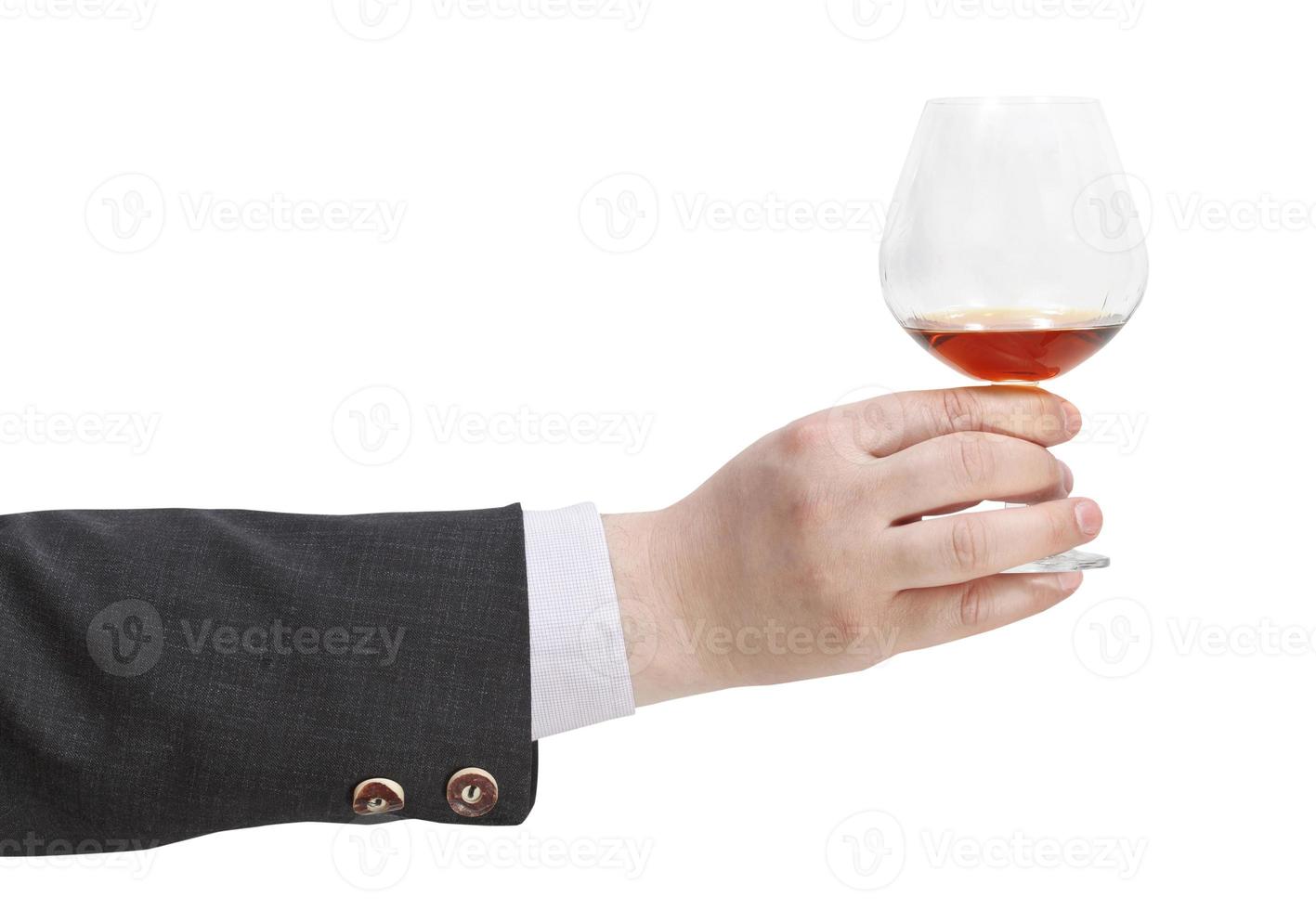 toast with brandy glass in businessman hand photo