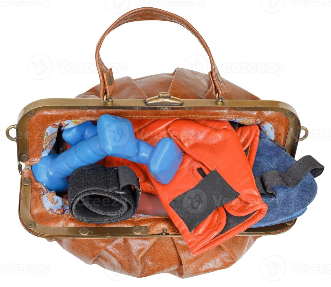 top view of bag with boxing gloves and dumbbells photo