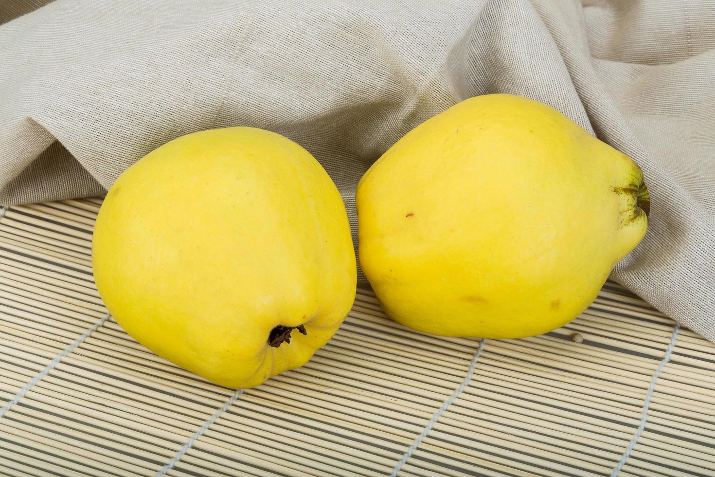 Quince on wooden background photo