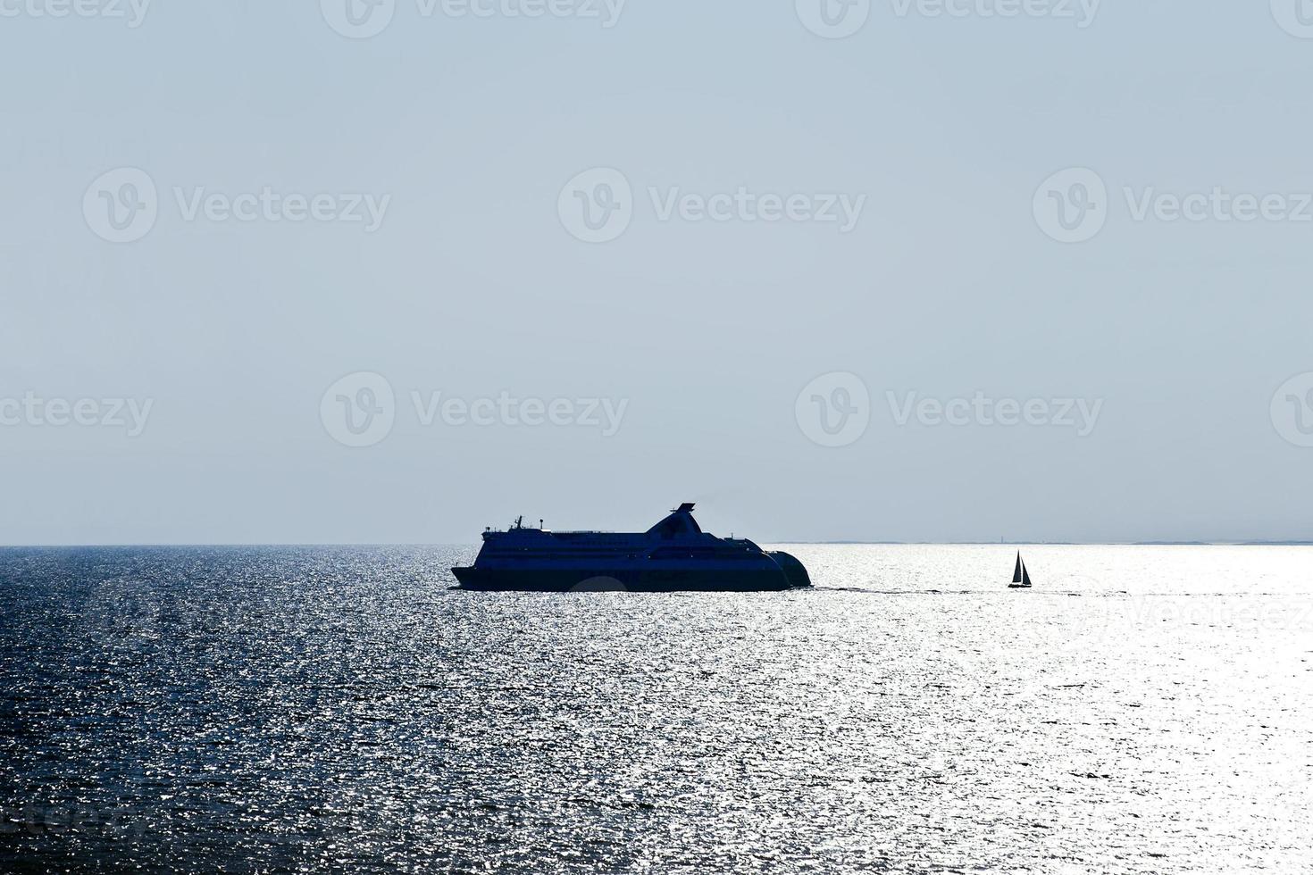 liner and boat in Baltic Sea in evening photo