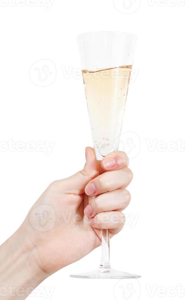 hand holds flute glass with champagne photo