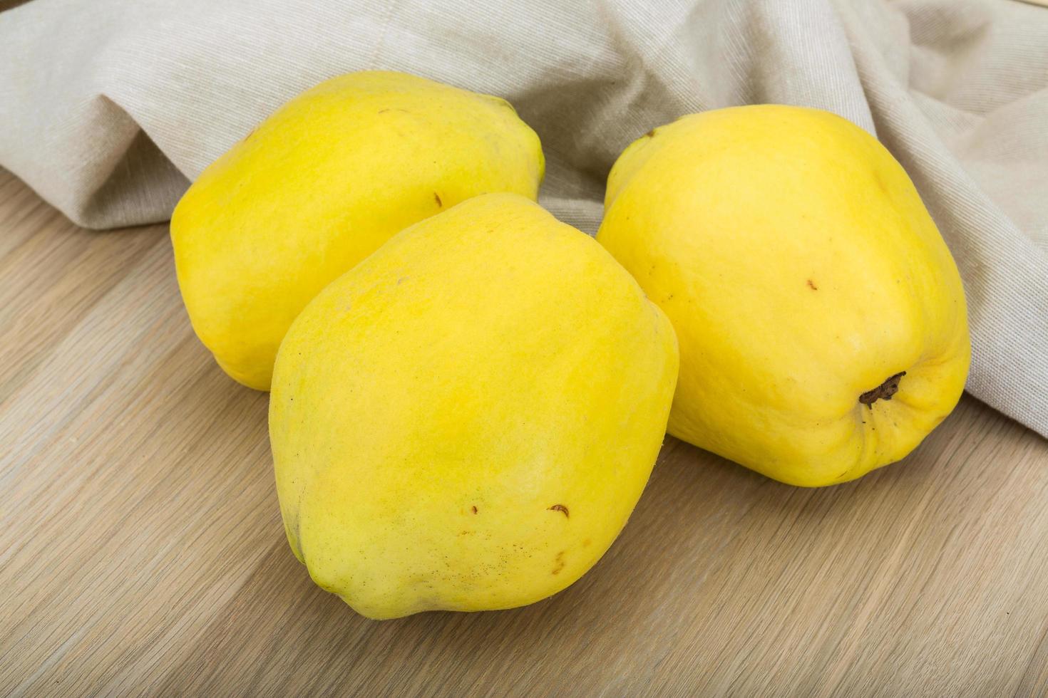 Quince on wooden background photo