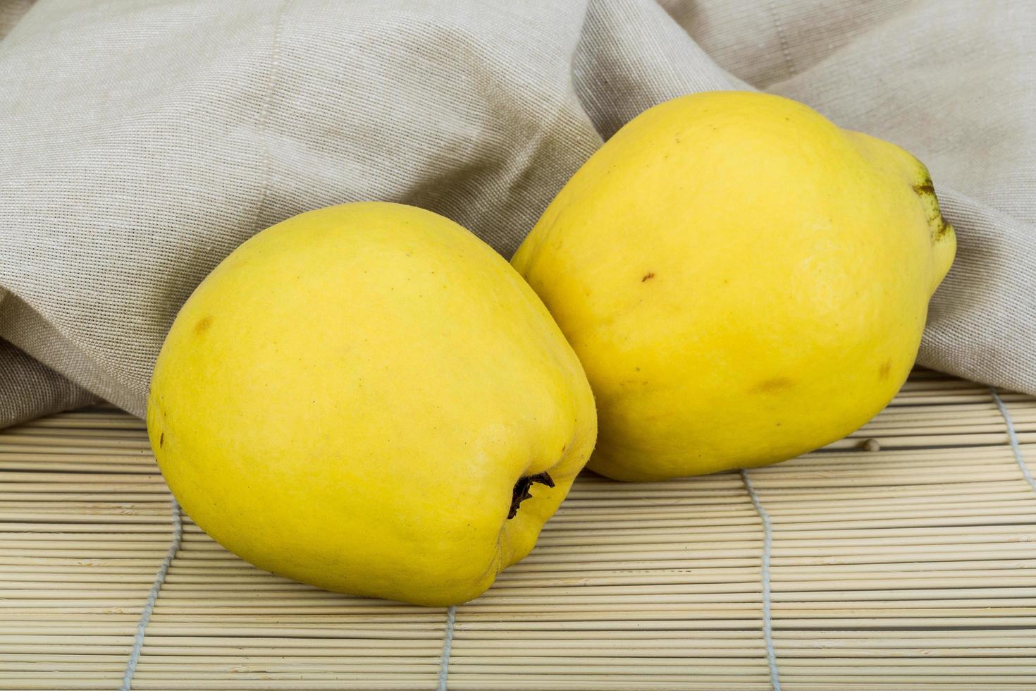 Quince on wooden background photo