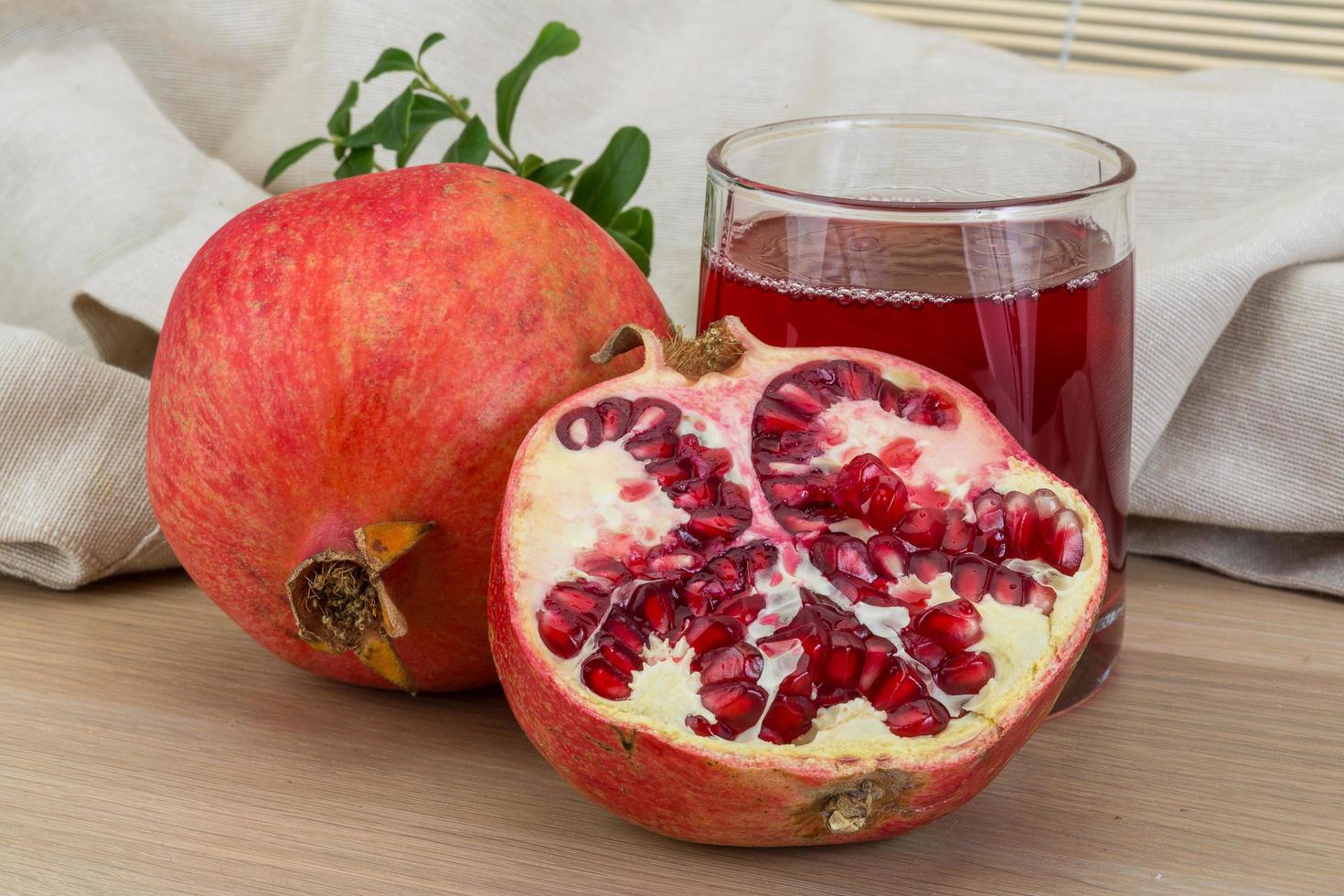 Pomecranet juice on wooden background photo