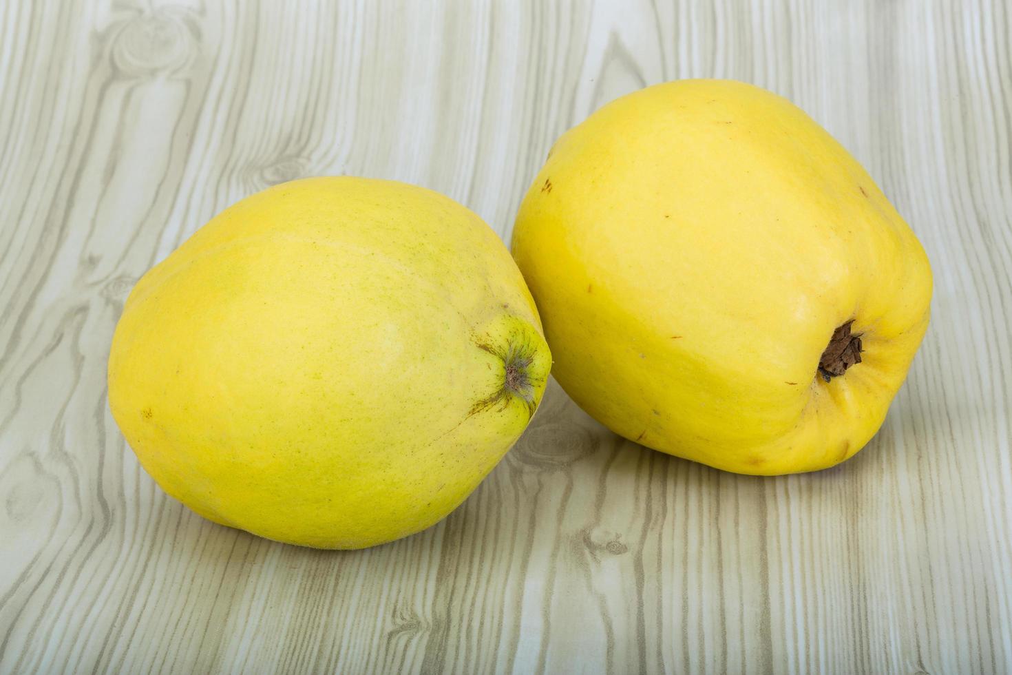 Quince on wooden background photo