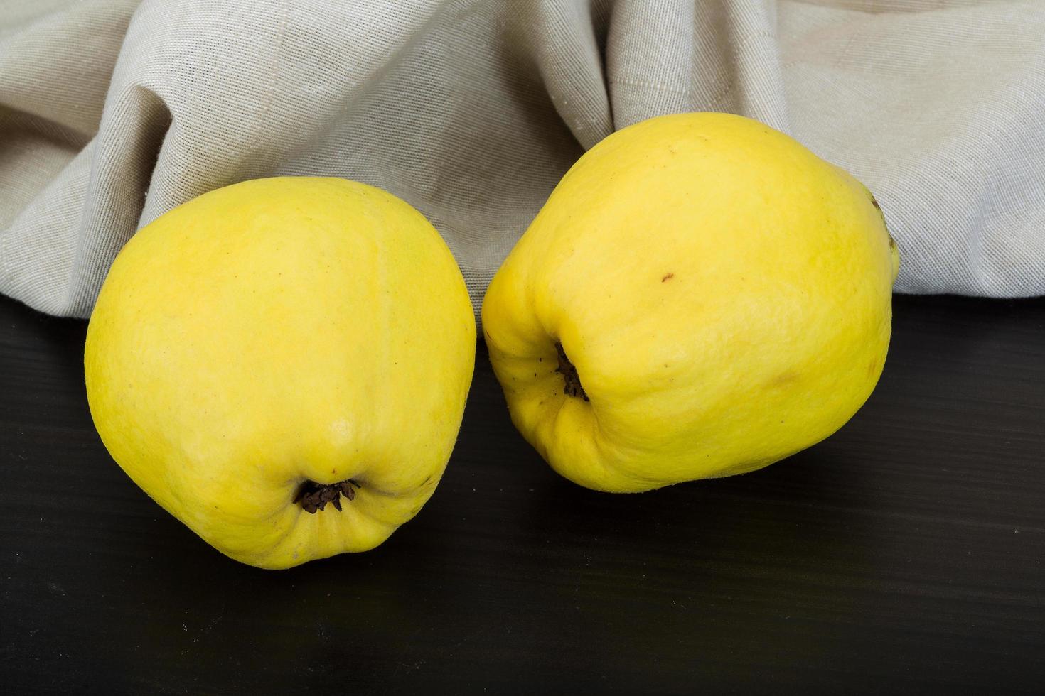 Quince on wooden background photo