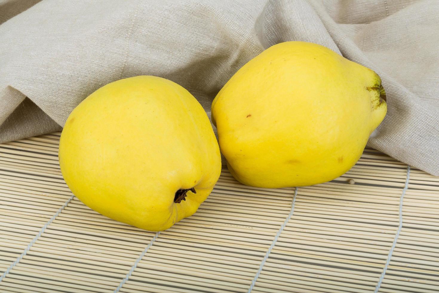 Quince on wooden background photo