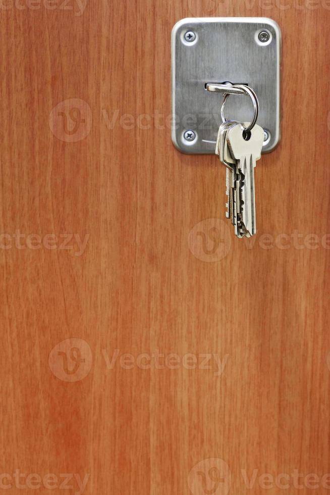several keys in keyhole of door photo