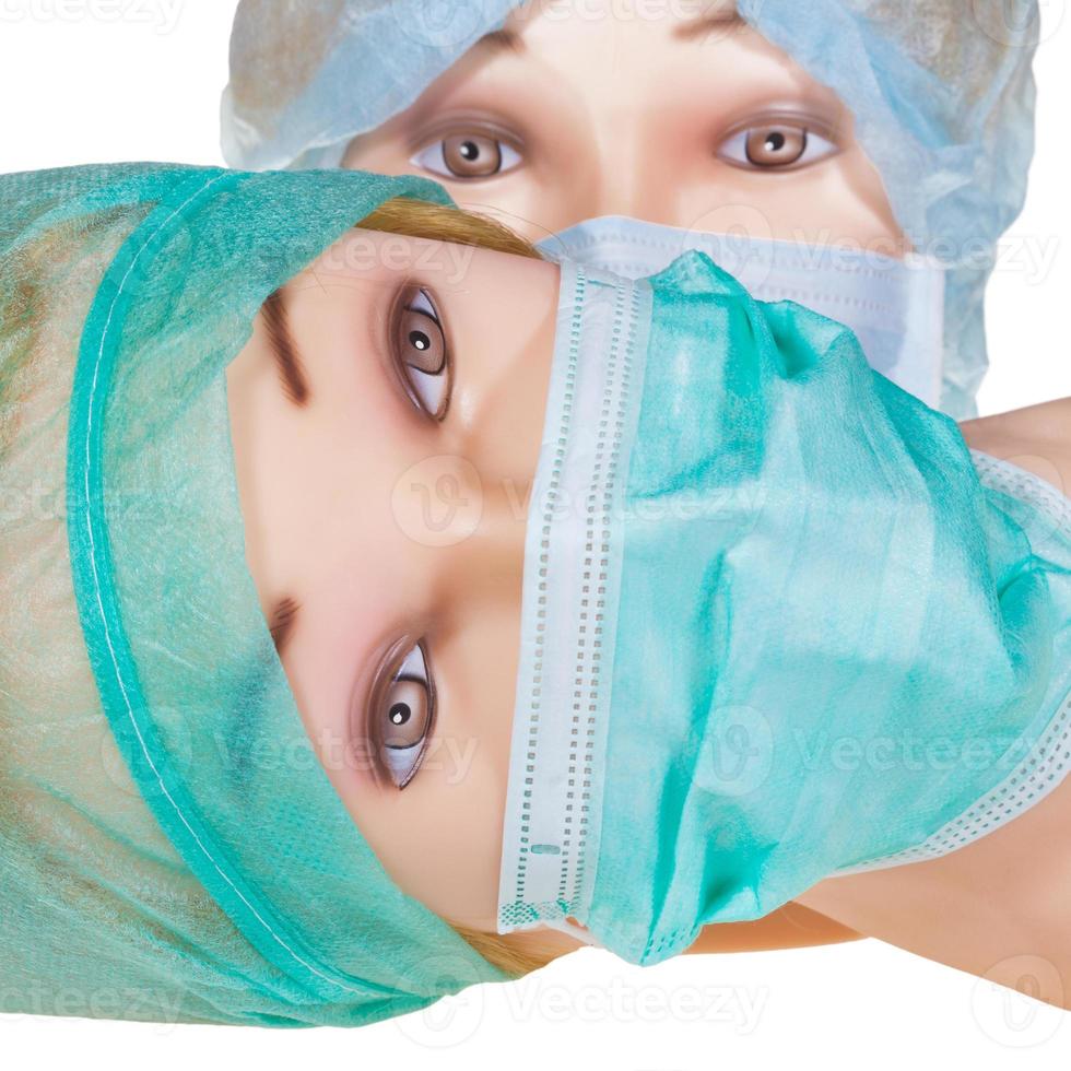 dummy doctor heads wearing textile surgical cap and mask photo