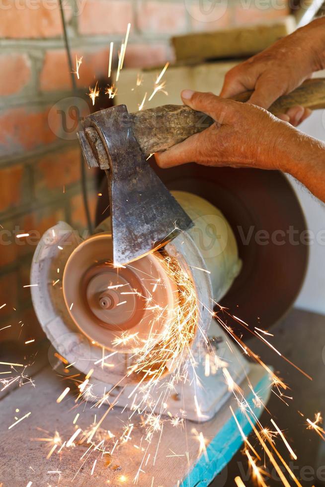 grinding bench axe using a grinding machine photo