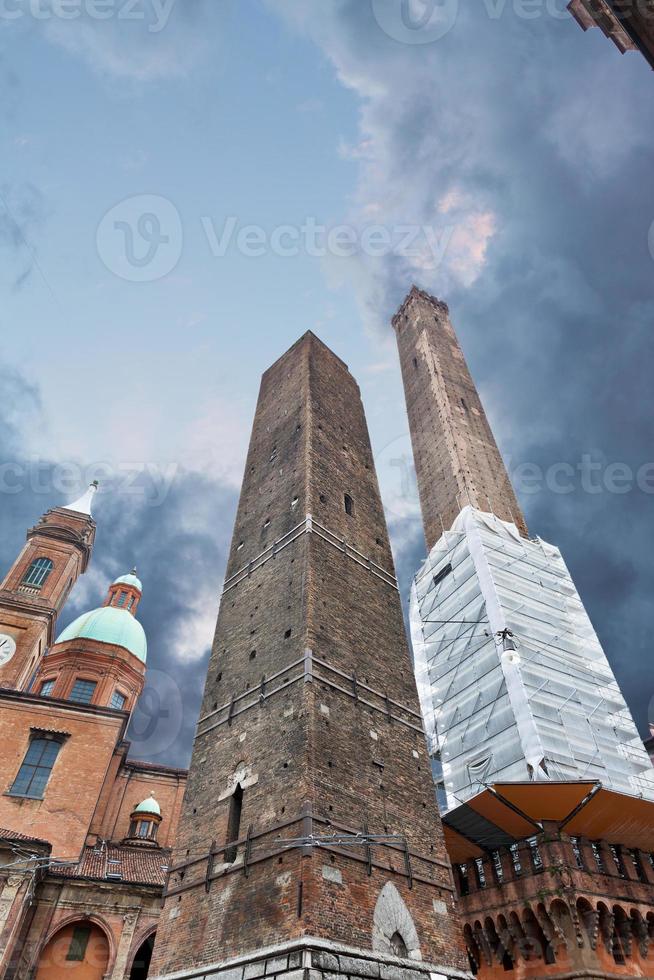 Two towers - symbol of city under dramatic sky in Bologna, Italy photo