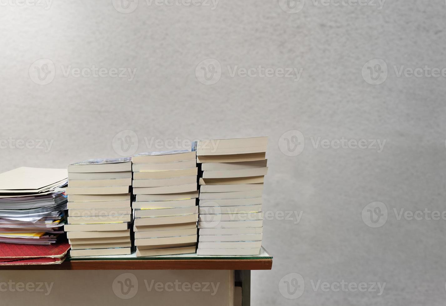stack of books on cement background table photo