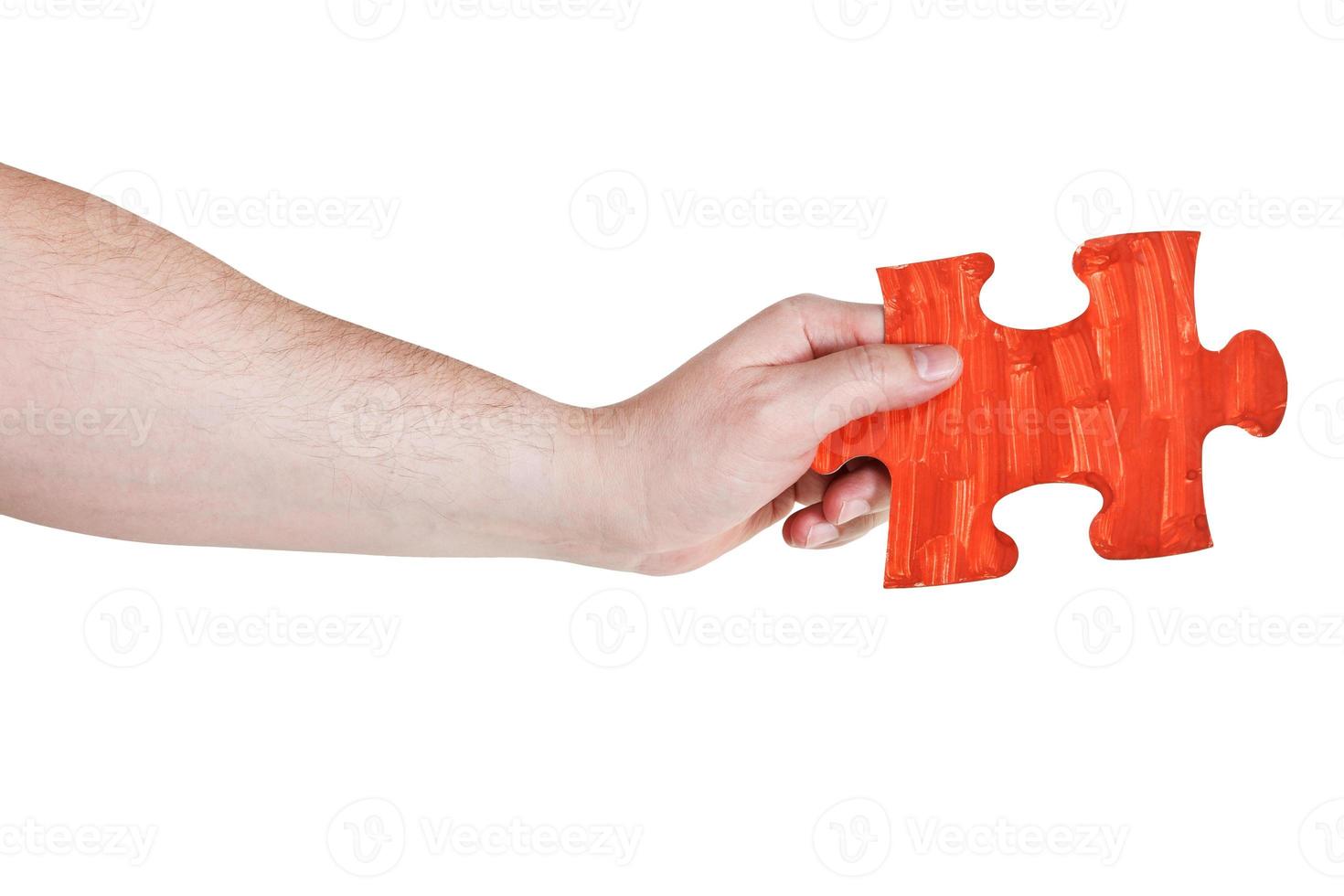 male hand with painted red puzzle piece photo