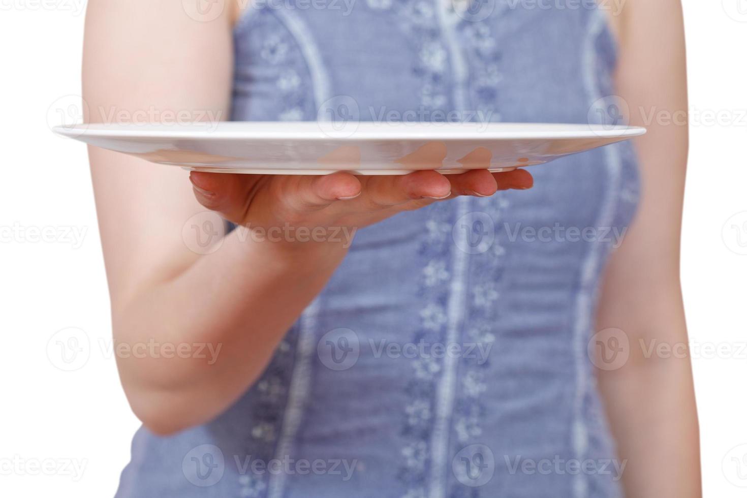 woman holds empty white plate on hand photo