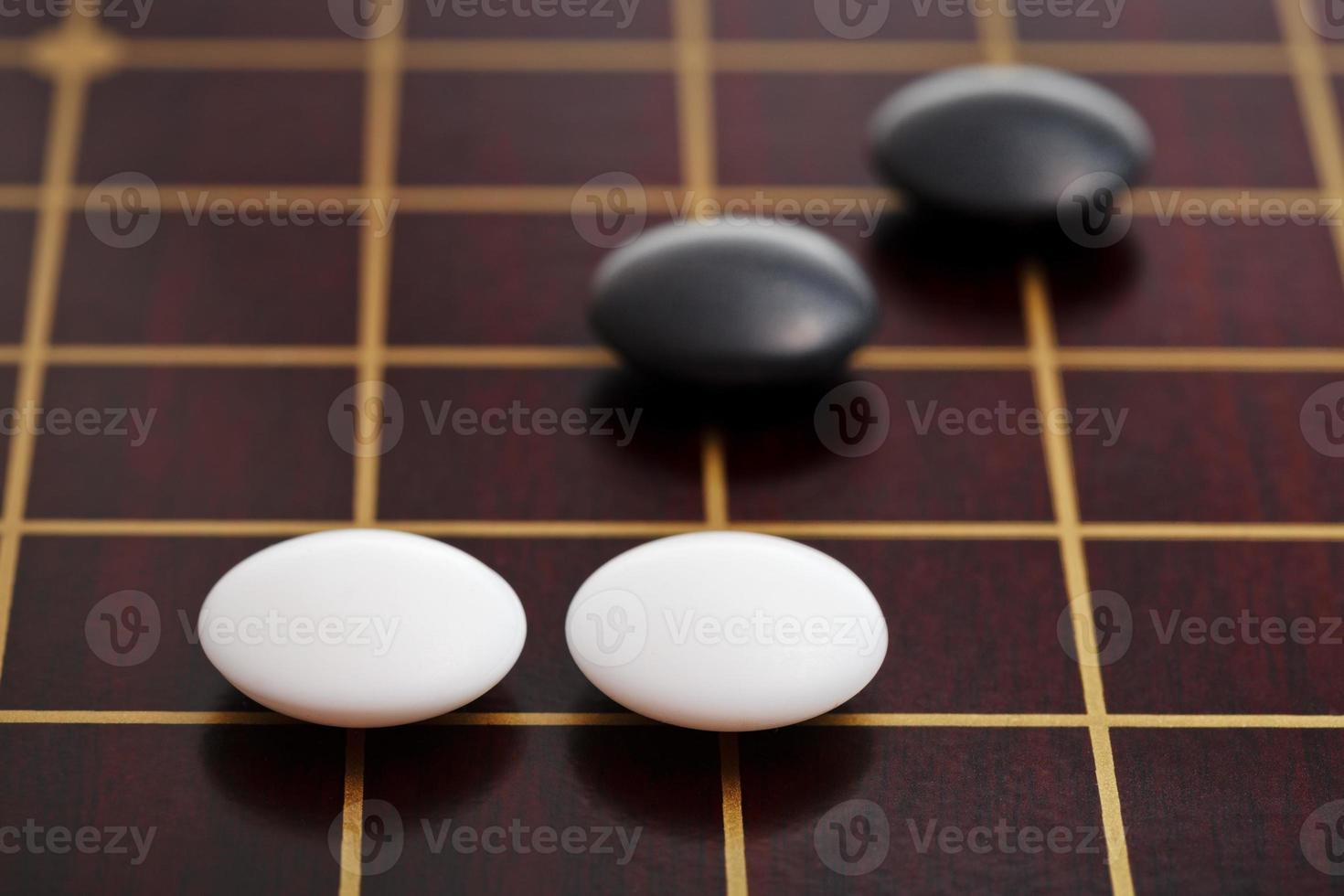 few stones during go game playing on goban photo