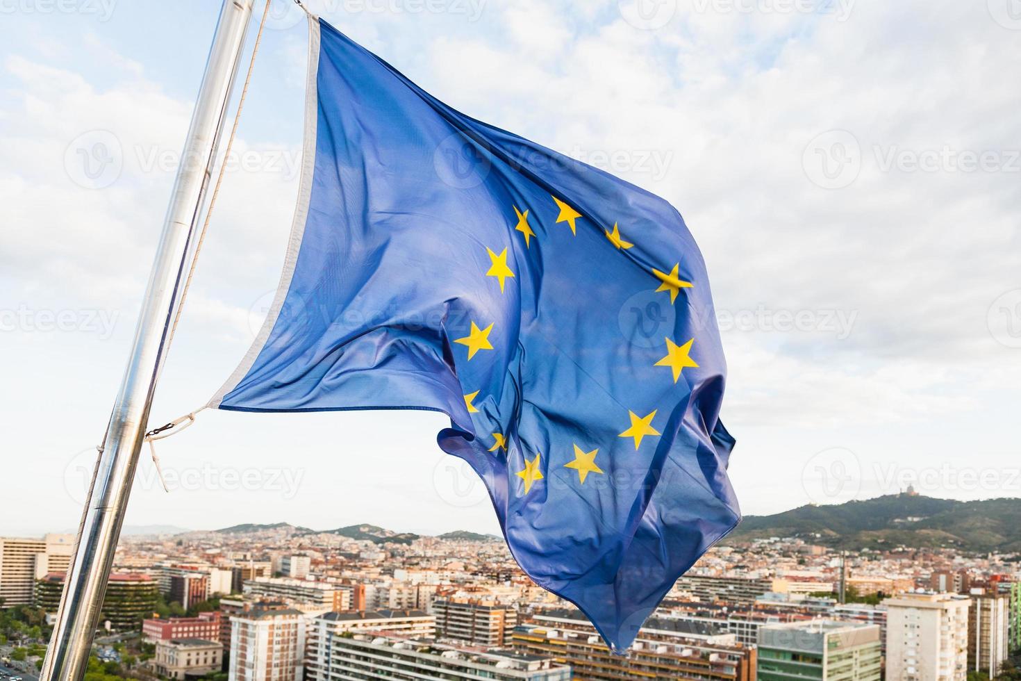 EU flag fluttering by wind above Barcelona photo