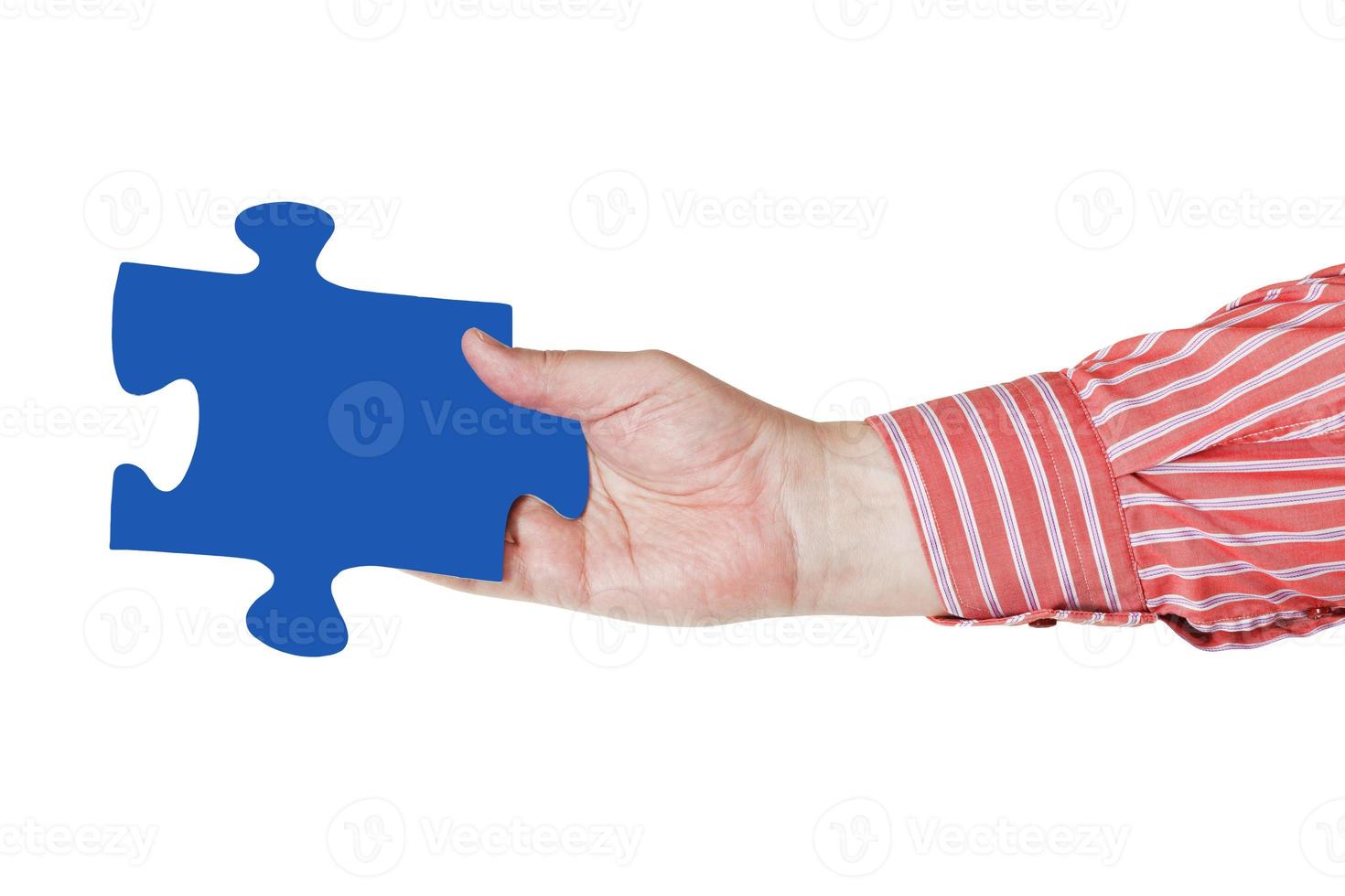 male hand with blue puzzle piece photo