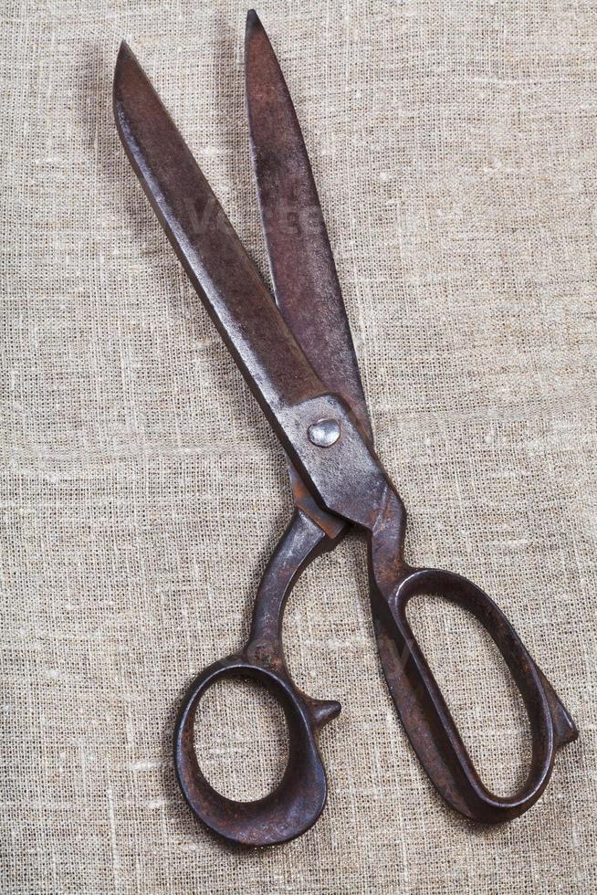 old tailor scissors on textile photo