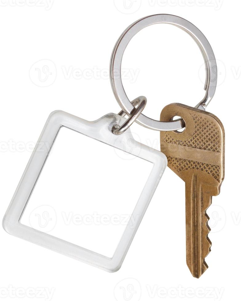 house brass key and square keychain on ring photo