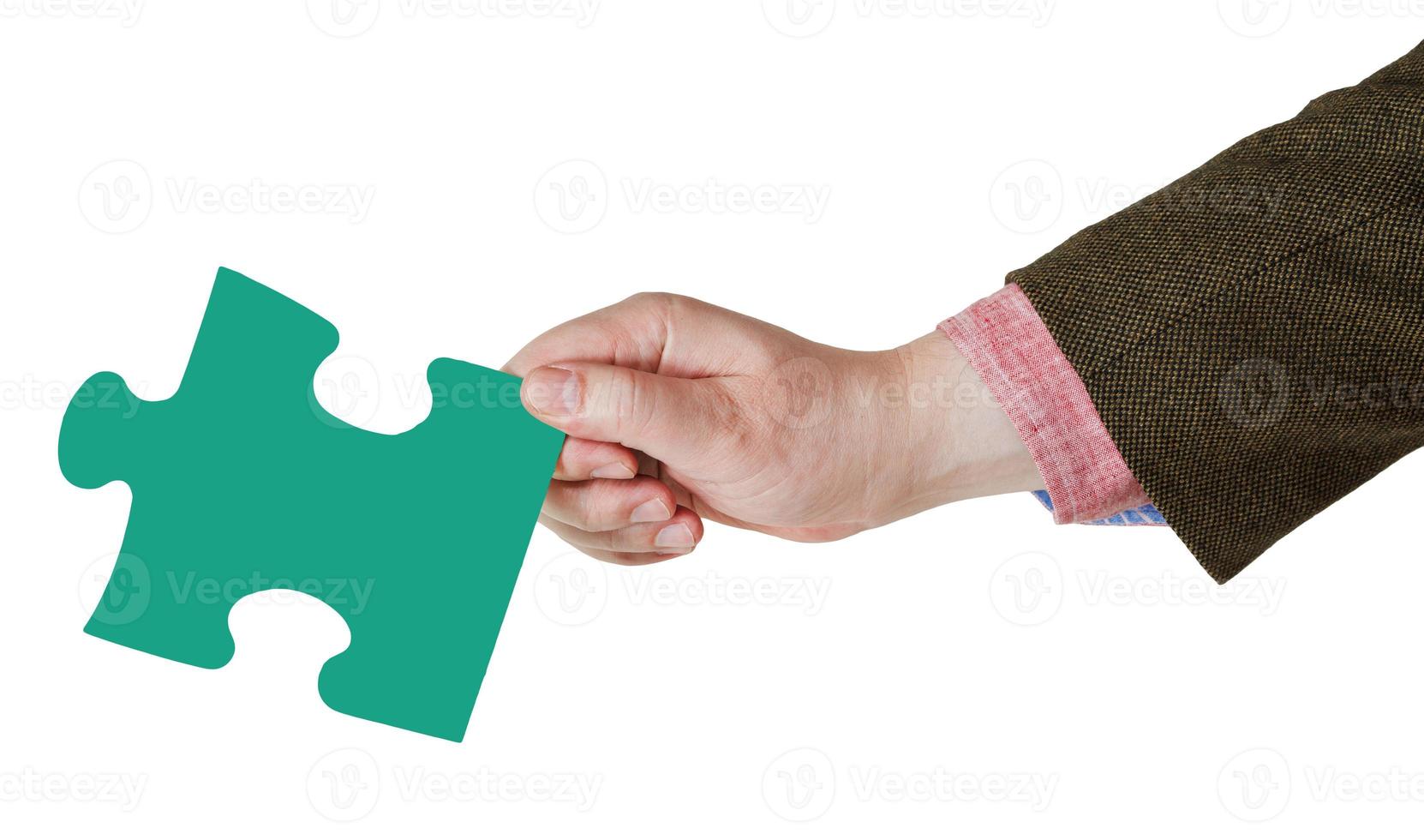 male hand with green puzzle piece photo