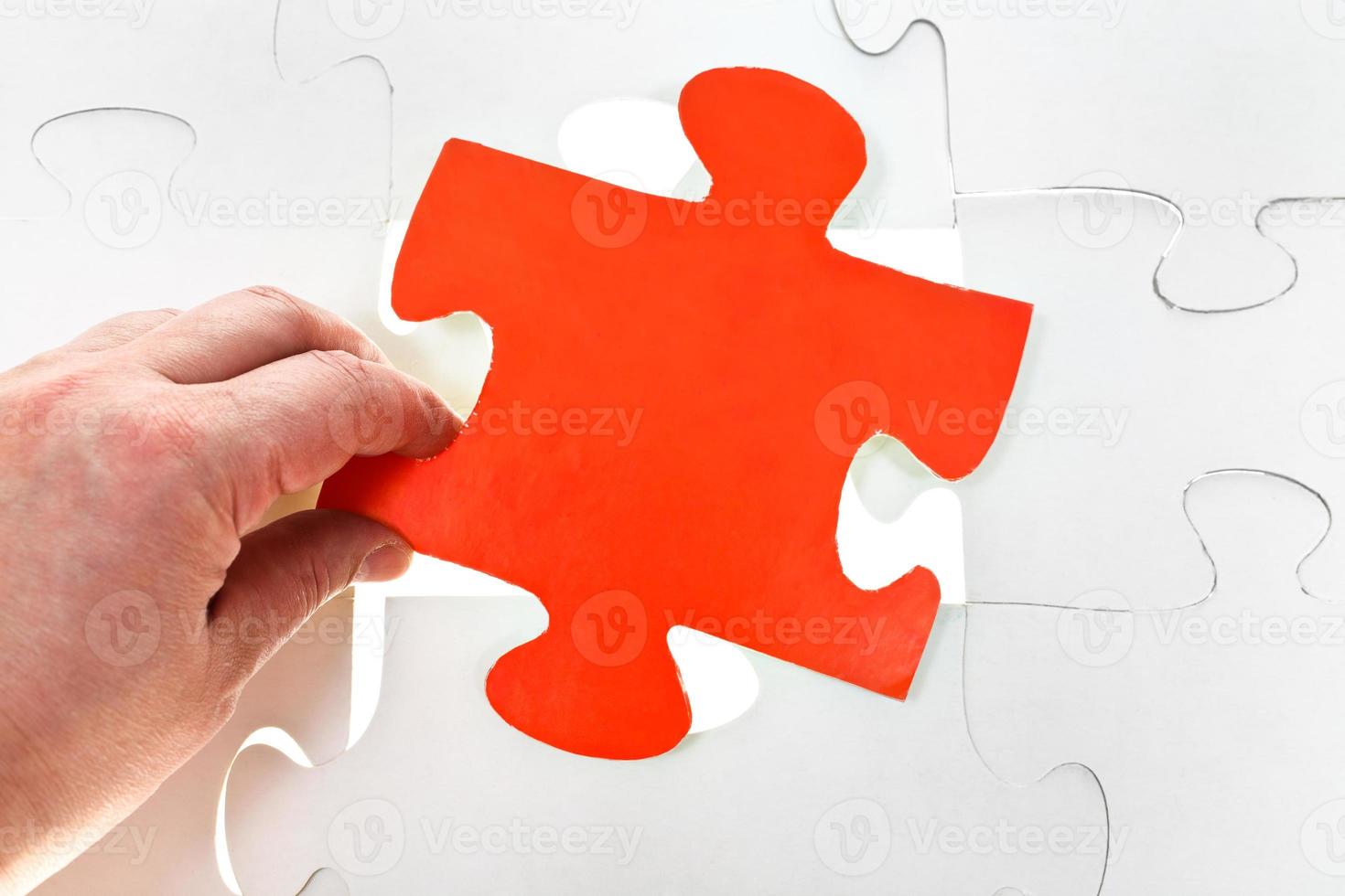 inserting red puzzle piece on free space photo