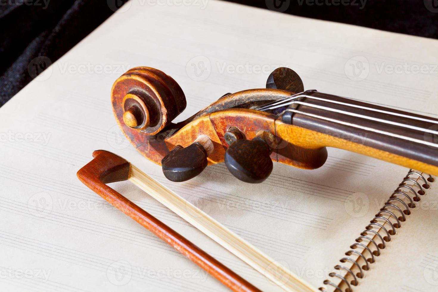 fiddle bow and scroll on music book photo