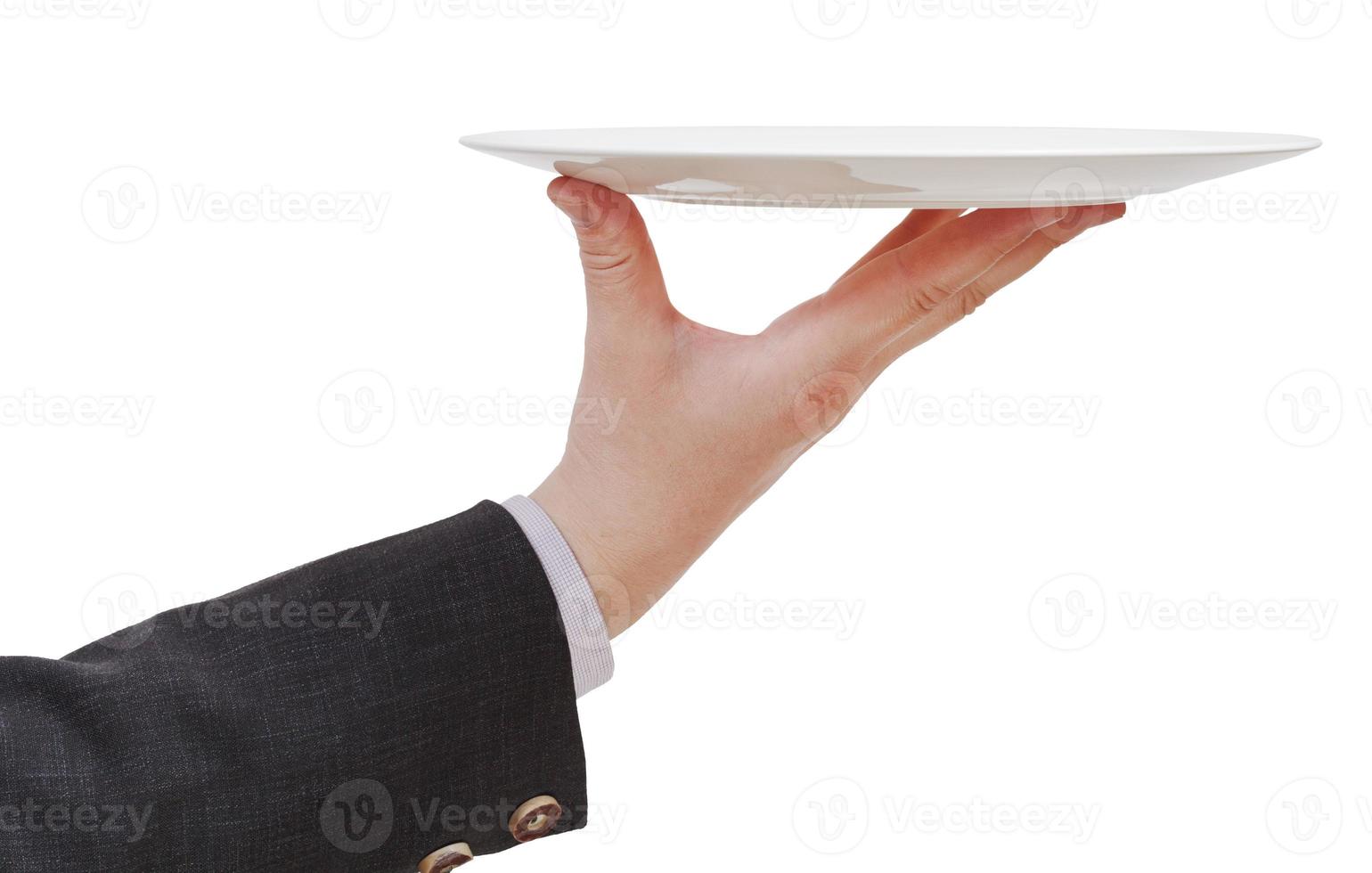 side view of hand with empty flat white plate photo