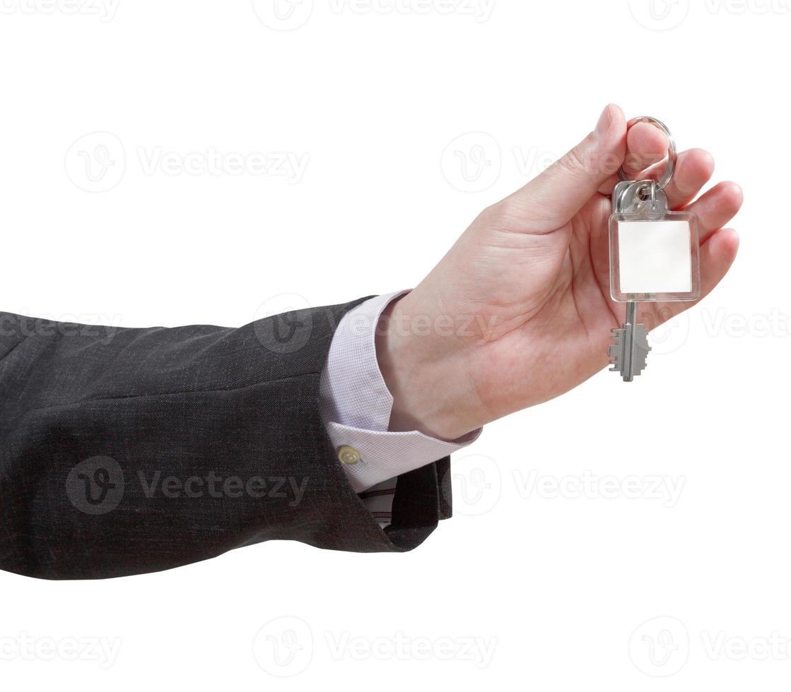 male hand with blank door key ring close up photo