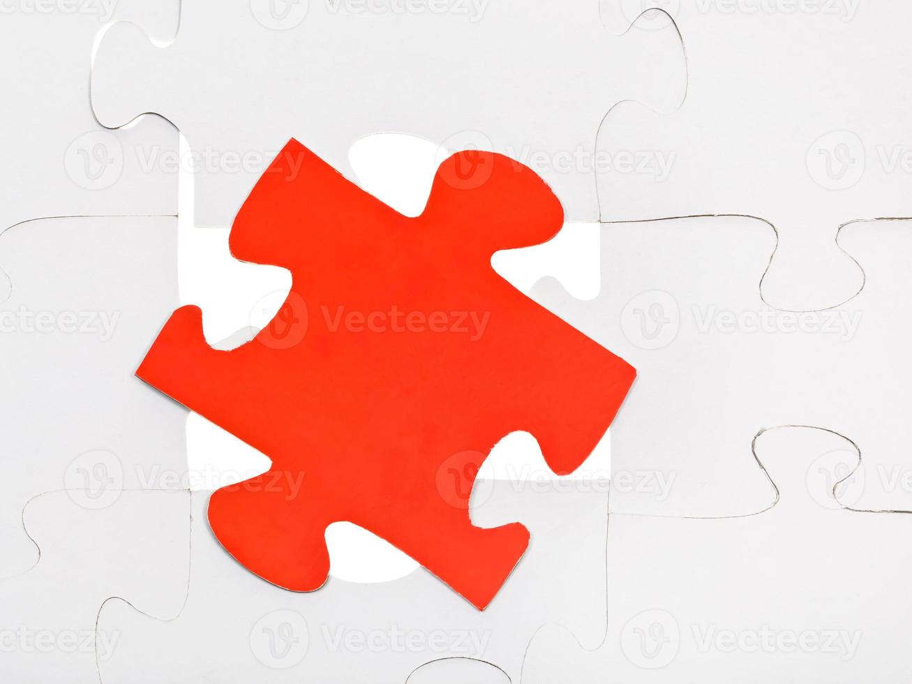 red piece on free space of assembled puzzles photo