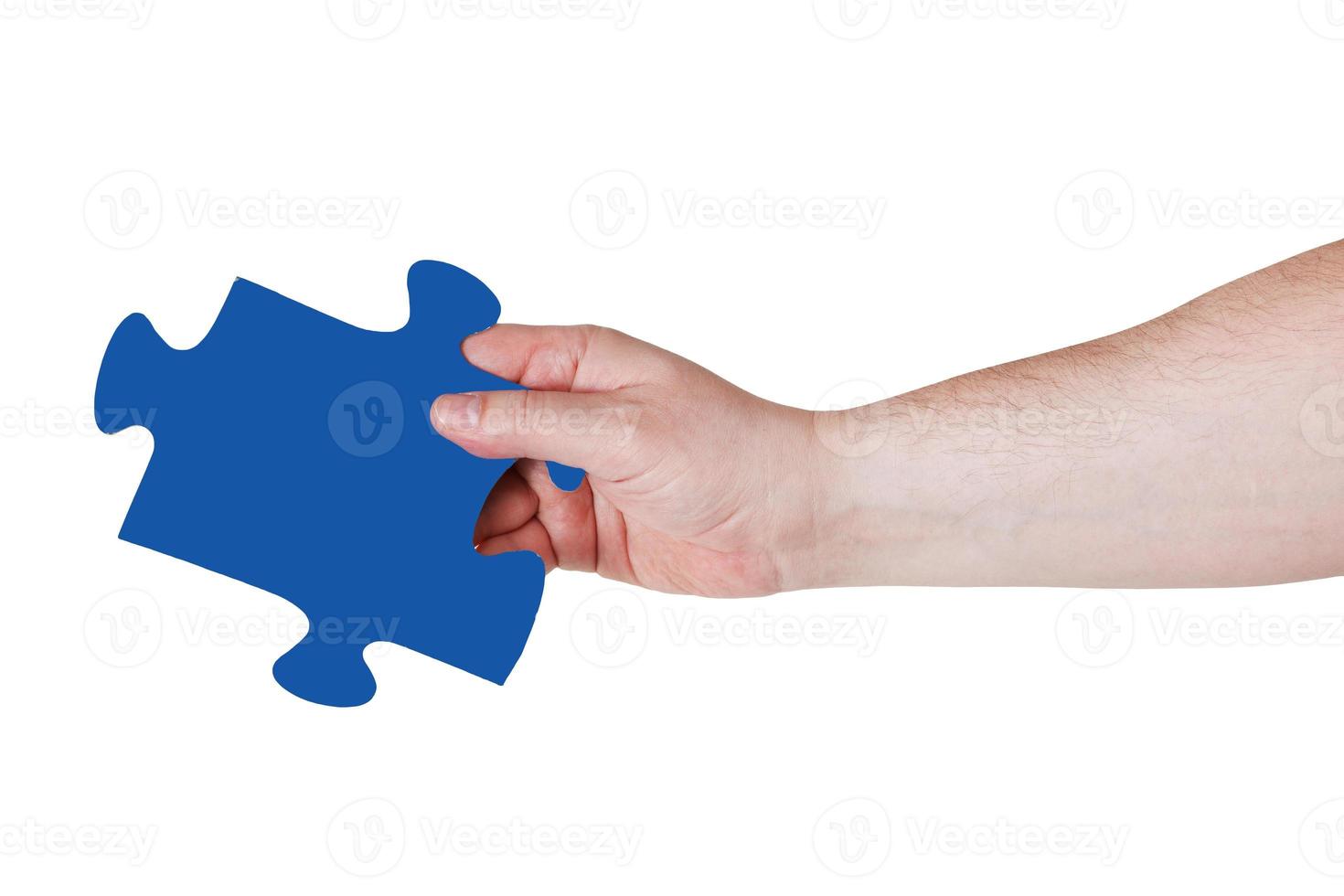 male hand with blue puzzle piece photo