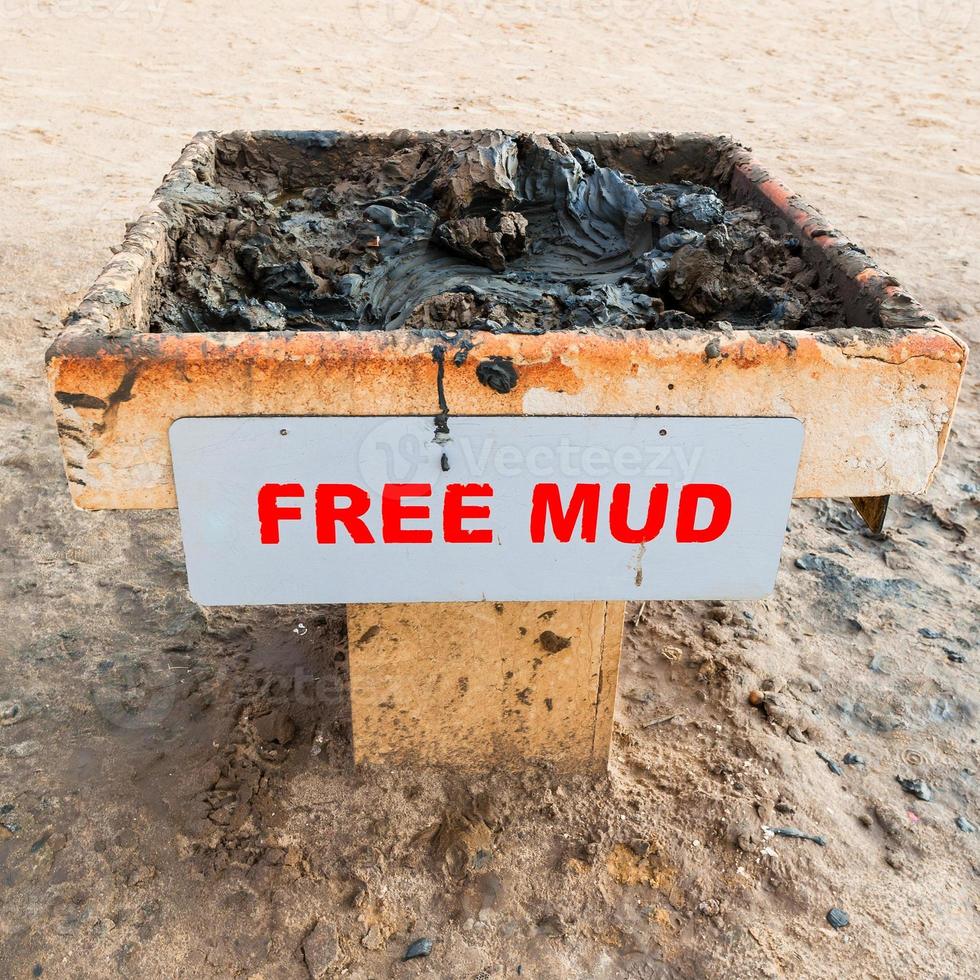 Tray with medical mud on beach of Dead Sea photo