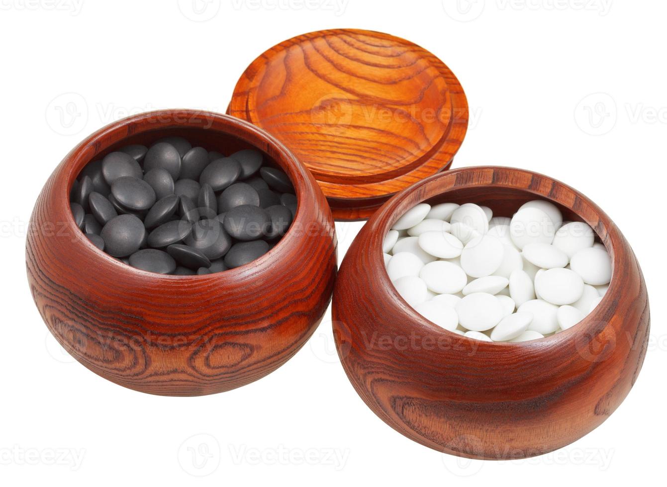 set of go game stones in wooden bowls photo