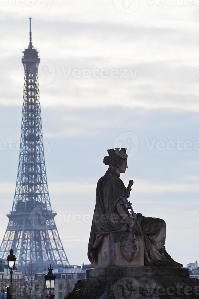 statue and Eiffel Tower in Paris photo