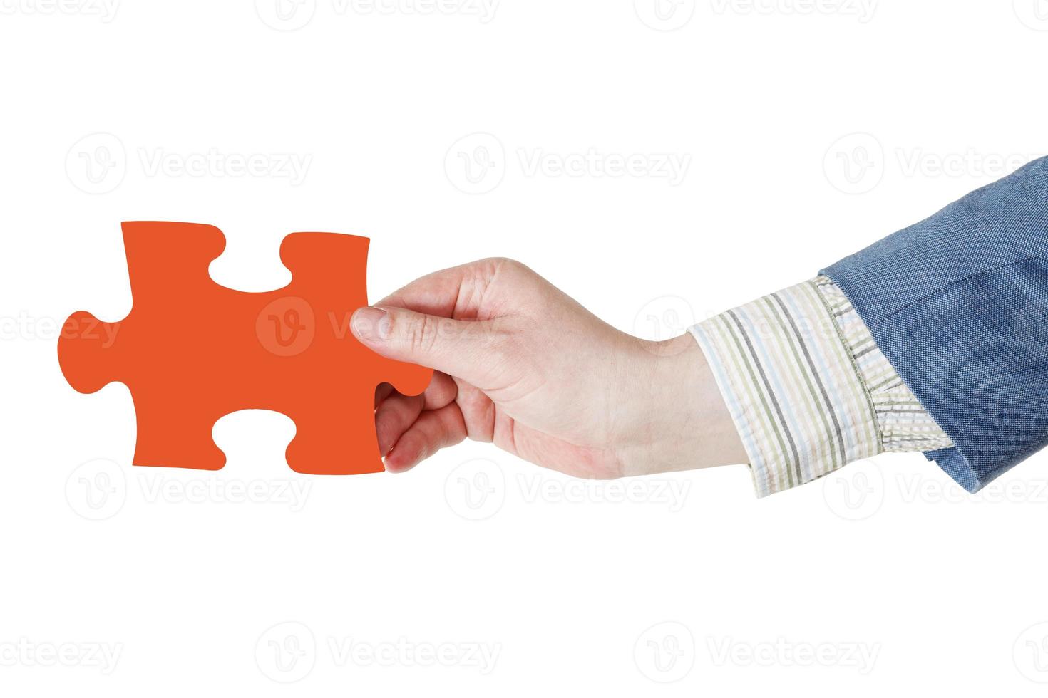male hand with red puzzle piece photo