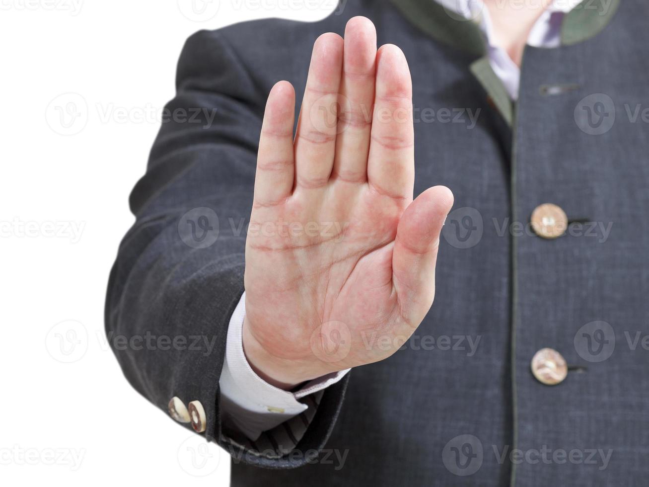 señal de stop por una palma - gesto de mano de hombre de negocios foto