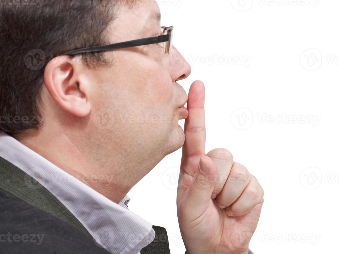 side view of businessman's finger near lips photo