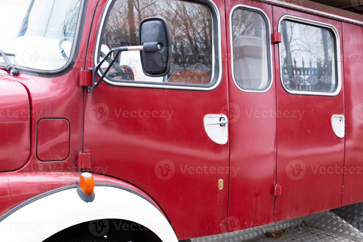 Old fire engine red and shiny. Old classic retro car. Old timer type, fire engine. photo