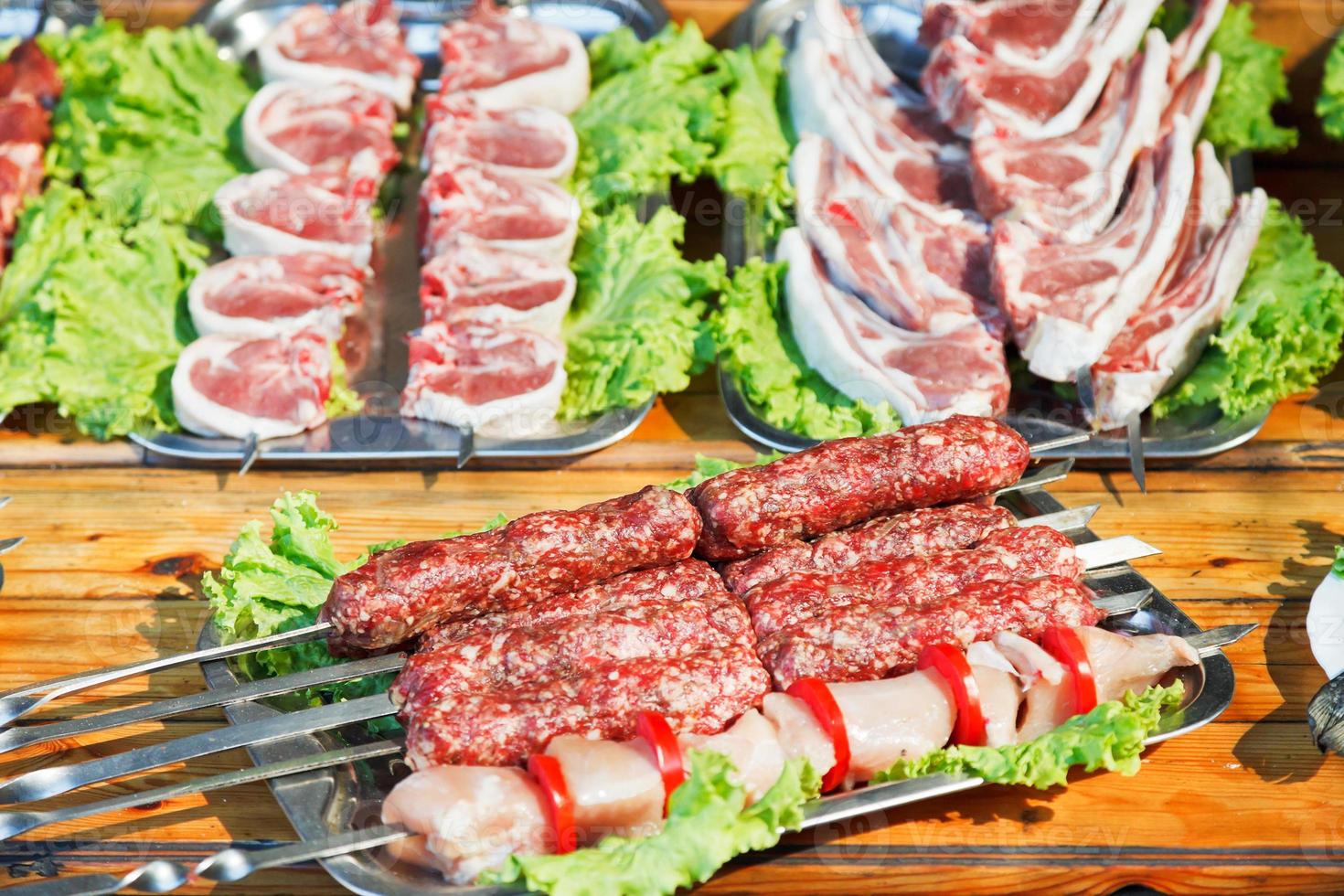 skewers of raw shish kebabs and lamb meat photo
