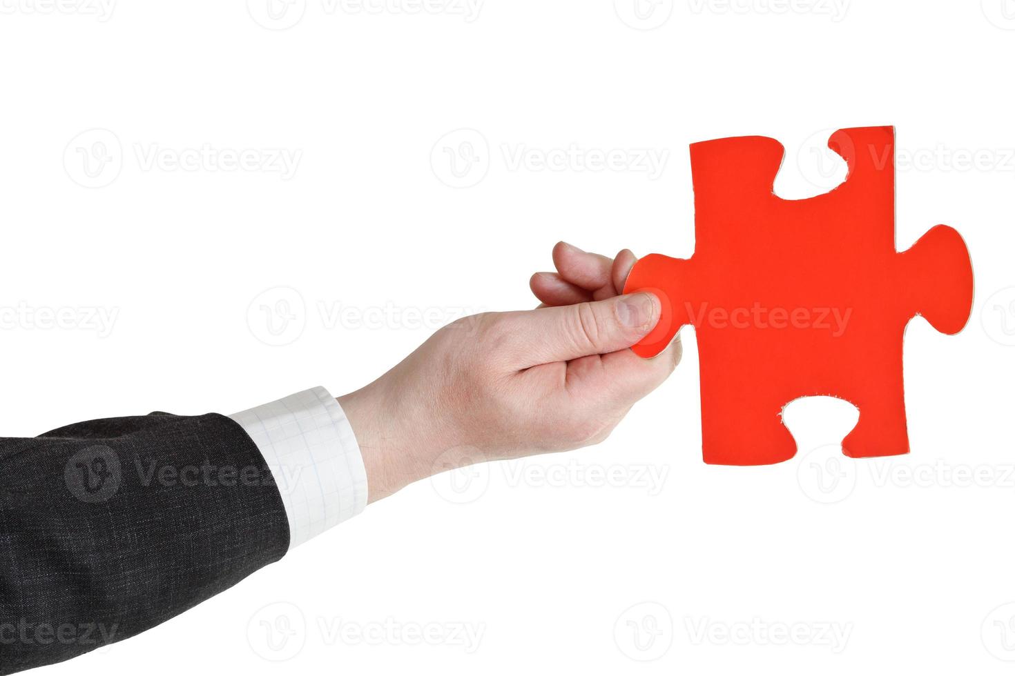 male hand holding big red paper puzzle piece photo