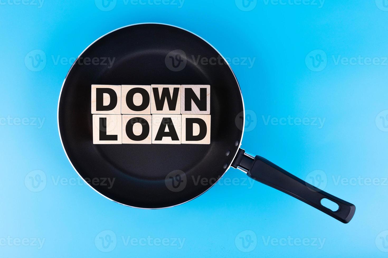 DOWNLOAD word, text written on wooden cubes, building blocks lying on a frying pan and a blue background. photo