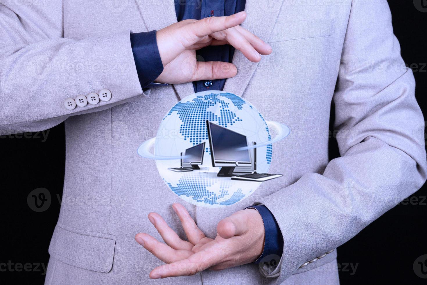 Businessman holds in hand Globe icon with computers, world wide web, web, internet technologies. Concept. photo