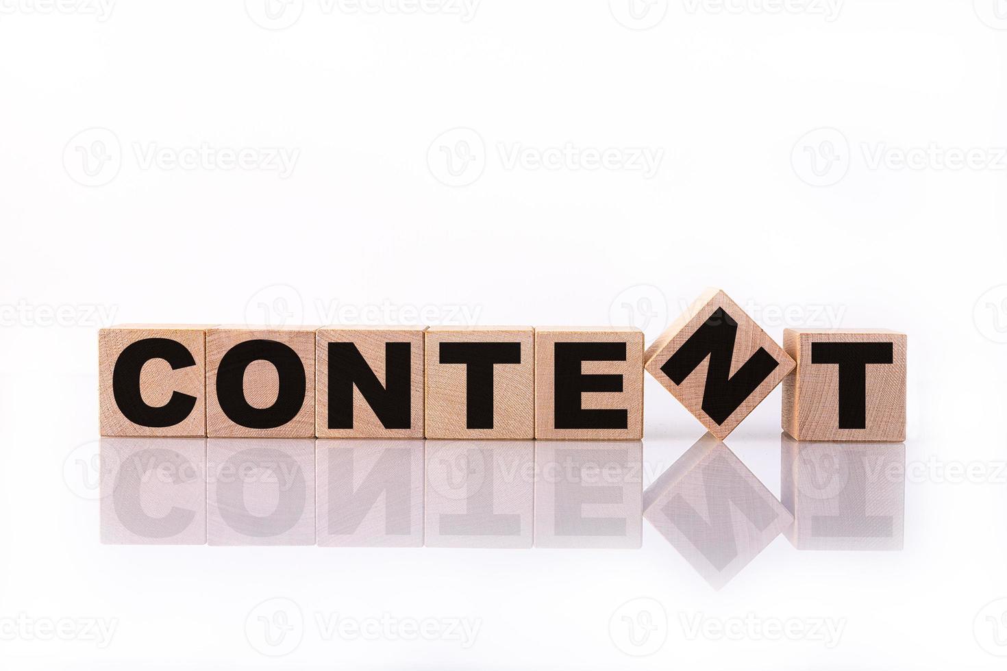 CONTENT word, text, written on wooden cubes, building blocks, over white background with reflection. photo