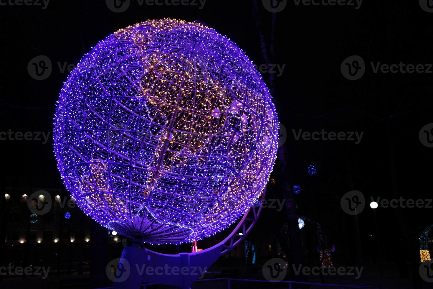 Globe, model of the earth in neon lights at night. photo