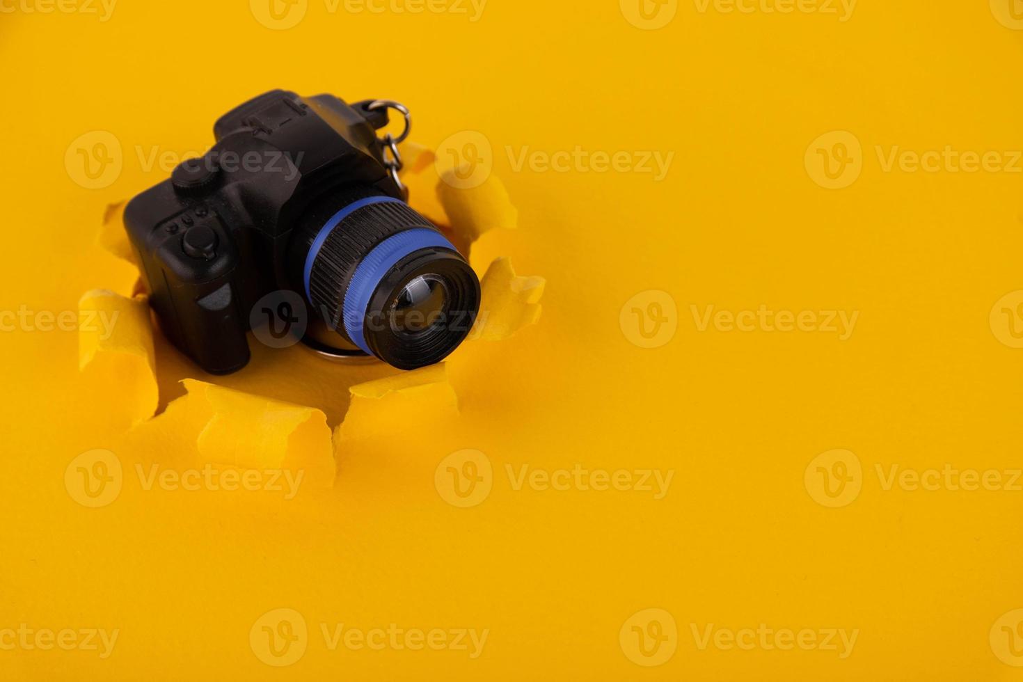 Toy camera on a yellow background. Concept. Copy space photo