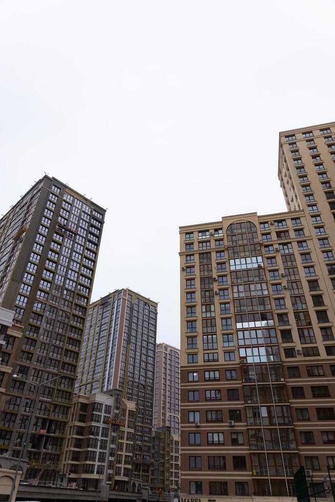 MINSK, BELARUS - DECEMBER 26, 2020, Angle view of textured background of modern multi-story glass skyscraper. photo