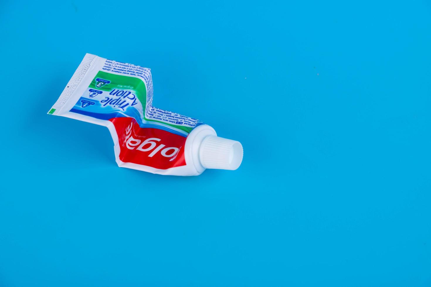 Moscow, Russia - February 15, 2021. Colgate toothpaste, pumping the press. Funny and minimal color still life photography photo