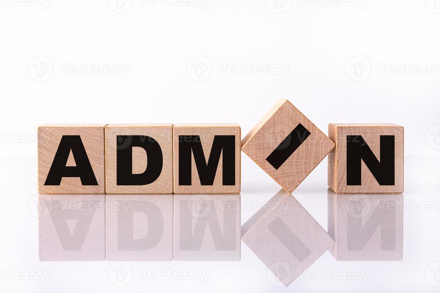 The word ADMIN concept is written on wooden cubes, on a white background with reflection. photo